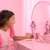 Mattel Barbie Deluxe Style baba fényes rózsaszín ruhában